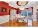 Formal dining room with hardwood floors, ornate cabinetry, and a chandelier at 180 Wesley Forest Dr, Fayetteville, GA 30214