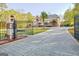 Ornate gate opens to a grand home and circular drive at 180 Wesley Forest Dr, Fayetteville, GA 30214