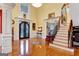 Two-story entryway with hardwood floors, double doors, and elegant staircase at 180 Wesley Forest Dr, Fayetteville, GA 30214