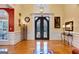 Elegant entryway with double doors, hardwood floors, and decorative wall art at 180 Wesley Forest Dr, Fayetteville, GA 30214