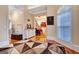 Spacious entryway with hardwood floors, decorative console table, and view to hallway at 180 Wesley Forest Dr, Fayetteville, GA 30214