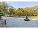 Landscaped yard with circular driveway and water fountain at 180 Wesley Forest Dr, Fayetteville, GA 30214