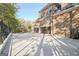 Three-car garage with large concrete driveway and black iron fencing at 180 Wesley Forest Dr, Fayetteville, GA 30214