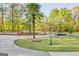 Landscaped entry with palm trees and gated community at 180 Wesley Forest Dr, Fayetteville, GA 30214