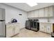 Laundry room with LG washer and dryer, and ample cabinetry at 180 Wesley Forest Dr, Fayetteville, GA 30214