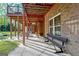 Covered patio with picnic table and bench at 180 Wesley Forest Dr, Fayetteville, GA 30214