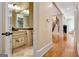 Elegant powder room with a vanity and view to the staircase at 180 Wesley Forest Dr, Fayetteville, GA 30214