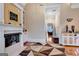 Fireplace sitting area with hardwood floors, built-in shelving, and views to hallway at 180 Wesley Forest Dr, Fayetteville, GA 30214