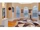 Sunlit sitting area with hardwood floors, fireplace, and arched windows at 180 Wesley Forest Dr, Fayetteville, GA 30214