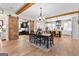 Open dining area with wood floors, decorative light fixture, and access to a modern kitchen at 0 Pinegate Way, Sharpsburg, GA 30277