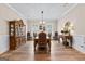 Elegant dining room with ornate furniture, hardwood floors, and natural light from shuttered windows at 0 Pinegate Way, Sharpsburg, GA 30277