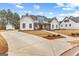 Spacious home featuring a long driveway, large yard, and classic exterior architecture at 0 Pinegate Way, Sharpsburg, GA 30277