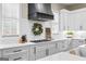 Detailed view of the kitchen featuring white cabinets, subway tile backsplash, and modern fixtures at 0 Pinegate Way, Sharpsburg, GA 30277