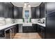 Kitchen with black cabinets, stainless steel appliances, white countertop and modern sink at 0 Pinegate Way, Sharpsburg, GA 30277