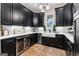 Modern kitchen featuring sleek black cabinetry, stainless steel appliances, and stylish lighting at 0 Pinegate Way, Sharpsburg, GA 30277