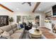 Cozy living room with exposed beams, fireplace, and sliding doors to outdoor pool area at 0 Pinegate Way, Sharpsburg, GA 30277