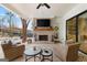 Outdoor living area featuring a brick fireplace, ceiling fan, and a pool in the background at 0 Pinegate Way, Sharpsburg, GA 30277