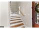 Staircase with wood and white painted treads and risers, wood handrail, and natural light at 0 Pinegate Way, Sharpsburg, GA 30277