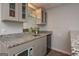 Basement bar with granite countertop and glass shelving at 3443 Pinemont Dr, Douglasville, GA 30135