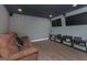 Finished basement with media room, including two large TVs and a comfortable couch at 3443 Pinemont Dr, Douglasville, GA 30135