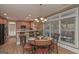 Kitchen features light wood cabinets, breakfast bar, and a dining area with chandelier at 3443 Pinemont Dr, Douglasville, GA 30135