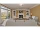 Living room with fireplace, built-in shelving, and a view of the backyard through large windows at 3443 Pinemont Dr, Douglasville, GA 30135