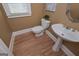 Powder room with pedestal sink, toilet and hardwood floor at 3443 Pinemont Dr, Douglasville, GA 30135