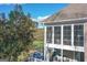 Screened porch with wood flooring, wicker furniture, and ceiling fans offers relaxing views at 3443 Pinemont Dr, Douglasville, GA 30135