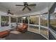 Relaxing sunroom with wicker furniture, ceiling fans, and serene views at 3443 Pinemont Dr, Douglasville, GA 30135