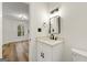 Updated bathroom with white vanity, quartz countertop, and black matte fixtures at 2473 Baker Nw Rd, Atlanta, GA 30318