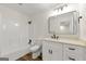 Basement bathroom with white vanity and large mirror at 2473 Baker Nw Rd, Atlanta, GA 30318