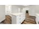 White kitchen island with quartz countertop and drawers, open to living area at 2473 Baker Nw Rd, Atlanta, GA 30318