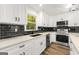 Modern kitchen features white cabinets, black tile backsplash, and stainless steel appliances at 2473 Baker Nw Rd, Atlanta, GA 30318