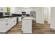 Modern kitchen featuring white cabinets, a large island, and black tile backsplash at 2473 Baker Nw Rd, Atlanta, GA 30318