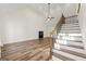 Spacious living room featuring hardwood floors, a fireplace, and a grand staircase at 2473 Baker Nw Rd, Atlanta, GA 30318