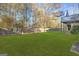 Large backyard with green grass and wooden fence at 180 Rock Hill Dr, Fayetteville, GA 30215