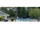 Community pool with a surrounding fence and adjacent clubhouse at 180 Rock Hill Dr, Fayetteville, GA 30215