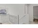 Upper hallway with white railings, wood floors, and a small bathroom at 360 Kaleb C, Mcdonough, GA 30252