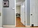 Bright hallway with hardwood floors leads to an office or bedroom at 141 Dodgen Place Dr, Hampton, GA 30228