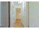 Light-colored hallway with light brown laminate flooring and doors to other rooms at 4487 Berkshire Rd, Forest Park, GA 30297