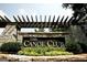 The Canoe Club entrance with stone pillars and wooden pergola at 145 Dockside Dr # 396, Fayetteville, GA 30215