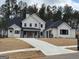 Two story home with white siding, black roof and a three car garage at 145 Dockside Dr # 396, Fayetteville, GA 30215