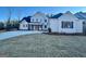 White two-story farmhouse with dark gray accents and a welcoming front porch at 145 Dockside Dr # 396, Fayetteville, GA 30215