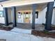 Covered front porch with brick flooring and black support columns at 145 Dockside Dr # 396, Fayetteville, GA 30215