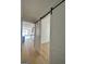 Light hallway with barn doors and light wood floors at 145 Dockside Dr # 396, Fayetteville, GA 30215