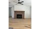 Living room with brick fireplace and hardwood floors at 145 Dockside Dr # 396, Fayetteville, GA 30215