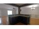 Dark kitchen island with granite countertop and cabinets at 2477 Briar Valley Way, Dacula, GA 30019