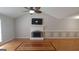 Living room with hardwood floors, fireplace, and ceiling fan at 2477 Briar Valley Way, Dacula, GA 30019