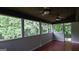 Bright screened porch with wood floors and wooded views at 2477 Briar Valley Way, Dacula, GA 30019