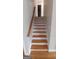 Elegant staircase with wood railings and hardwood flooring at 2477 Briar Valley Way, Dacula, GA 30019